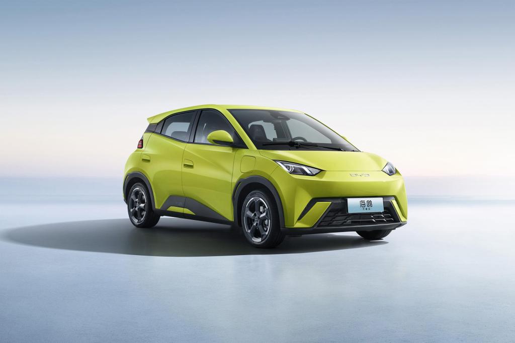 A vibrant green BYD Seagull compact electric vehicle, positioned at a slight angle, showcasing its modern design and sleek body shape against a minimalistic background.