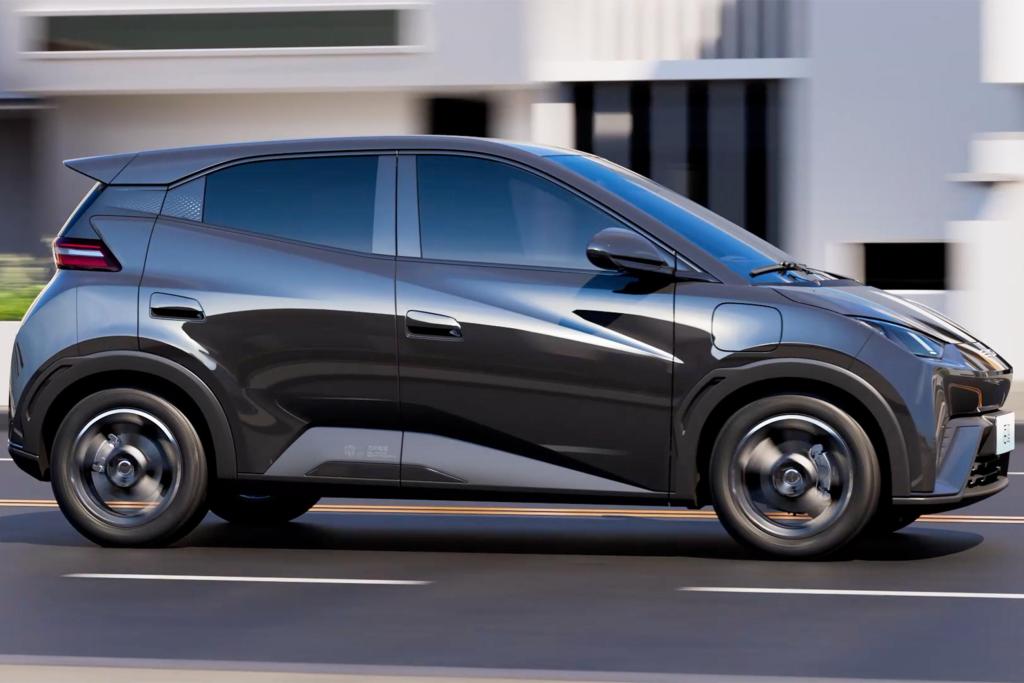 A black BYD Seagull electric vehicle in motion, showcasing its sleek design and modern features against a blurred urban backdrop.