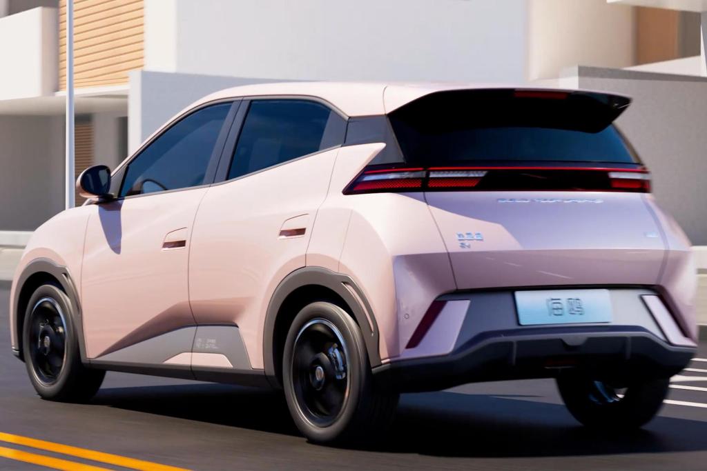 A rear view of a BYD Seagull electric vehicle in a modern urban setting, showcasing its sleek design and unique color.