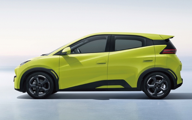 Side view of a bright yellow electric vehicle showcasing its sleek design and modern features.