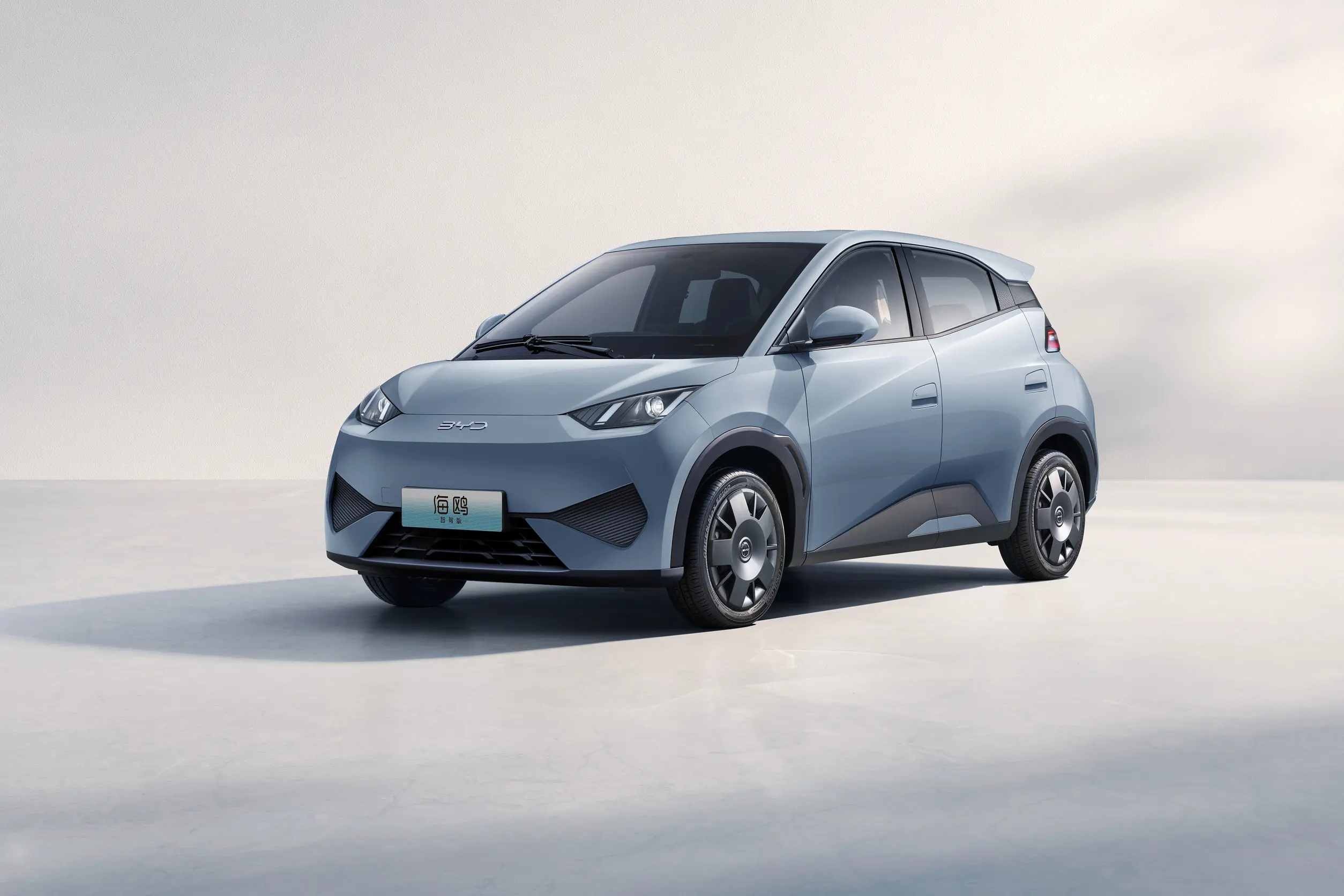 A sleek, modern electric vehicle, the BYD Seagull, displayed in a light setting, showcasing its stylish design and compact size.